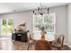 Cozy dining area featuring a wooden table, chairs, and natural light from a window, perfect for meals at 21 Cambridge Dr, Angier, NC 27501