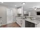 Modern kitchen featuring white cabinets, granite countertops, stainless steel appliances, and hardwood flooring at 21 Cambridge Dr, Angier, NC 27501