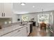 Modern kitchen with granite countertops, dining area, stainless steel appliances, and wood-look floors at 21 Cambridge Dr, Angier, NC 27501