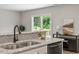Bright kitchen with granite countertops and stainless steel sink, with a view of the backyard at 21 Cambridge Dr, Angier, NC 27501