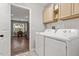 Bright laundry room with modern appliances and tile floor with cabinets for storage at 21 Cambridge Dr, Angier, NC 27501