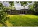 Beautiful landscaped backyard with lush green grass, and a modern house at 2129 Ridge Rd, Raleigh, NC 27607