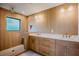 Modern bathroom with wood-textured walls, double sink vanity, and a tiled shower at 2129 Ridge Rd, Raleigh, NC 27607