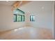 Spacious bedroom with hardwood floors, large window, and exposed wooden beams at 2129 Ridge Rd, Raleigh, NC 27607