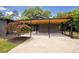 Spacious covered parking featuring a wood ceiling and concrete driveway at 2129 Ridge Rd, Raleigh, NC 27607
