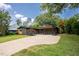 Modern home exterior with a long driveway, mature trees, and a well-manicured lawn enhancing its curb appeal at 2129 Ridge Rd, Raleigh, NC 27607