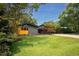 Charming home exterior with well-kept lawn, a carport, and beautiful landscaping, perfect for outdoor living at 2129 Ridge Rd, Raleigh, NC 27607