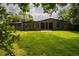 Well-manicured front yard featuring lush green lawn and mature trees surrounding a modern home, enhancing curb appeal at 2129 Ridge Rd, Raleigh, NC 27607