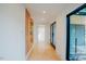Bright hallway with light wood floors leading to a room with a view at 2129 Ridge Rd, Raleigh, NC 27607