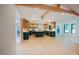 Expansive kitchen features custom cabinets, center island, stainless appliances and a vaulted ceiling with wooden beams at 2129 Ridge Rd, Raleigh, NC 27607