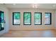 Living room with four large windows providing natural light and scenic views at 2129 Ridge Rd, Raleigh, NC 27607