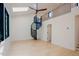 Open-concept living room featuring a spiral staircase, hardwood floors, and lots of natural light at 2129 Ridge Rd, Raleigh, NC 27607