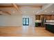 Bright living room featuring hardwood floors with view into kitchen featuring stainless fridge and custom cabinets at 2129 Ridge Rd, Raleigh, NC 27607