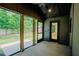 Covered patio with stained concrete floor offers view of the lush backyard at 2129 Ridge Rd, Raleigh, NC 27607