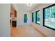 Bright sunroom with hardwood floors and large windows offering natural light and backyard views at 2129 Ridge Rd, Raleigh, NC 27607
