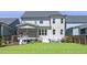 Well-maintained backyard with a screened-in porch, outdoor seating area, and a fun playset for children at 217 Tumbling River Dr, Wendell, NC 27591