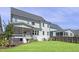 Lush backyard with a screened porch, playset, and comfortable seating, perfect for outdoor enjoyment at 217 Tumbling River Dr, Wendell, NC 27591