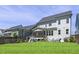Spacious backyard featuring a screened-in porch, lush green grass, and a playset at 217 Tumbling River Dr, Wendell, NC 27591