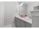 Modern bathroom with double sinks, sleek gray cabinets, and contemporary fixtures for a clean look at 217 Tumbling River Dr, Wendell, NC 27591