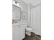 Bright bathroom featuring white cabinetry, silver mirror, shower with curtain and a toilet at 217 Tumbling River Dr, Wendell, NC 27591