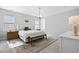 Bright, airy bedroom showcasing a decorative rug and chandelier creating an inviting space at 217 Tumbling River Dr, Wendell, NC 27591