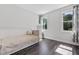 Bright bedroom with light walls, hardwood flooring, two windows, and daybed at 217 Tumbling River Dr, Wendell, NC 27591