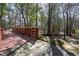 View of a scenic trail with a wooden bridge, bordered by trees and a lush forest landscape at 217 Tumbling River Dr, Wendell, NC 27591
