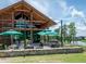 Stunning clubhouse featuring an outdoor patio with ample seating overlooking the lake at 217 Tumbling River Dr, Wendell, NC 27591