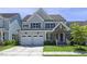 Charming two-story home with a well-manicured lawn, attached two-car garage, and inviting front porch at 217 Tumbling River Dr, Wendell, NC 27591