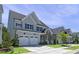 Well-maintained two-story home with a gray exterior, spacious driveway, and manicured lawn in a friendly neighborhood at 217 Tumbling River Dr, Wendell, NC 27591