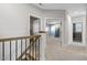 Carpeted hallway with open doorways, and a staircase at 217 Tumbling River Dr, Wendell, NC 27591