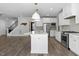 Open-concept kitchen with a large island, granite countertops, stainless steel appliances, and modern pendant lighting at 217 Tumbling River Dr, Wendell, NC 27591