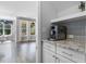 Stylish kitchen features granite countertops, stainless steel coffee maker, and access to a bright living area at 217 Tumbling River Dr, Wendell, NC 27591