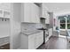 Bright kitchen featuring granite counters, stainless appliances, gas range and gray subway tile backsplash at 217 Tumbling River Dr, Wendell, NC 27591