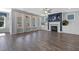 Bright living room with hardwood floors, a fireplace, built-in cabinets, and a view of the outdoors at 217 Tumbling River Dr, Wendell, NC 27591