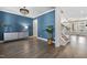 Elegant living room with a modern chandelier, sleek console, and stylish hardwood floors at 217 Tumbling River Dr, Wendell, NC 27591
