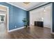 Stylish living room featuring a modern sideboard, elegant decor, and beautiful hardwood floors at 217 Tumbling River Dr, Wendell, NC 27591