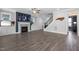 Inviting living area with a fireplace, built-in cabinets, hardwood floors, and staircase at 217 Tumbling River Dr, Wendell, NC 27591