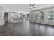 Open-concept living area with hardwood floors, a modern kitchen, and access to a bright sunroom at 217 Tumbling River Dr, Wendell, NC 27591