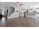Spacious living area with hardwood floors, staircase, and an open kitchen layout at 217 Tumbling River Dr, Wendell, NC 27591