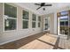 Large porch with wood flooring, ceiling fan, and multiple entry points into the home at 217 Tumbling River Dr, Wendell, NC 27591