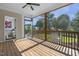 Spacious screened porch with wood floors, ceiling fan, and views of the backyard at 217 Tumbling River Dr, Wendell, NC 27591