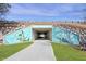 A tunnel passage with blue sky and greenery surrounding the mural-painted entrance at 217 Tumbling River Dr, Wendell, NC 27591
