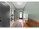 Inviting entryway featuring neutral paint, wood floors, storage cabinet and wood bench with a front door wreath at 2201 Millbank Village Ct # 101, Raleigh, NC 27610