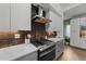 Modern kitchen features stainless steel appliances, a subway tile backsplash, and sleek white and gray cabinetry at 2201 Millbank Village Ct # 101, Raleigh, NC 27610