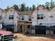 New construction townhomes showcase modern design with covered entries and durable siding, still in the building phase at 27 Calluna Dr, Clayton, NC 27520