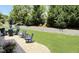 Outdoor patio area with blue patio furniture and a manicured lawn at 2725 Belmont View Loop, Cary, NC 27519
