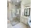 Bathroom featuring a glass enclosed shower, neutral decor and a granite topped vanity with decorative mirror at 2725 Belmont View Loop, Cary, NC 27519
