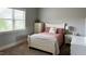 Comfortable bedroom with neutral decor, plush carpet and a large window bringing in lots of natural light at 2725 Belmont View Loop, Cary, NC 27519