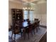 Elegant dining room with table, 8 chairs, a china cabinet, and overhead lighting at 2725 Belmont View Loop, Cary, NC 27519
